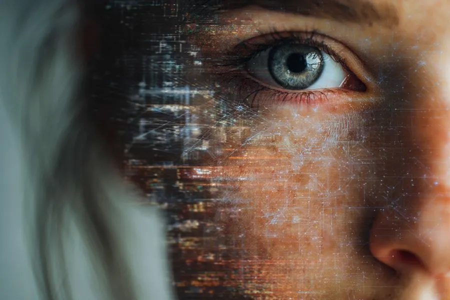 Half of a girls face zoomed in with pixel-like texture on top.